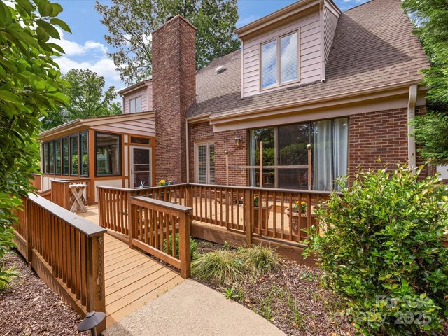 5104 Top Seed Ct, Charlotte, NC 28226 - rear view of property with a sunroom, brick siding, a shingled roof, and a deck