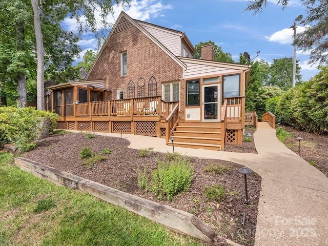 5104 Top Seed Ct, Charlotte, NC 28226 - back of property with a sunroom, a wooden deck, brick siding, and a chimney