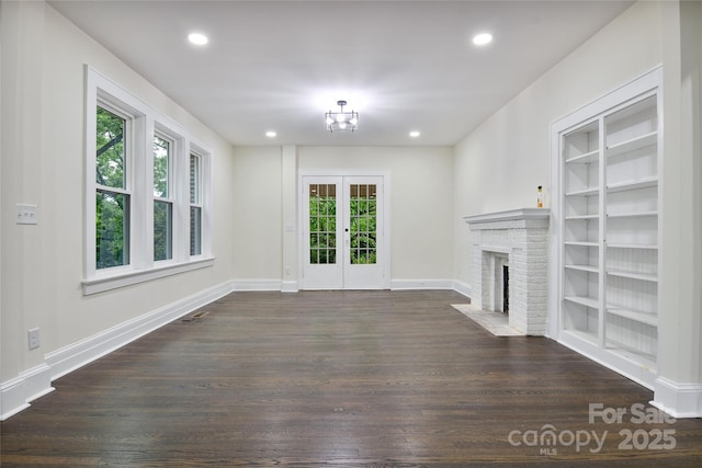 1783 Radio Station Rd, Newton, NC 28658 - unfurnished living room featuring dark wood-type flooring, a fireplace, recessed lighting, built in shelves, and baseboards