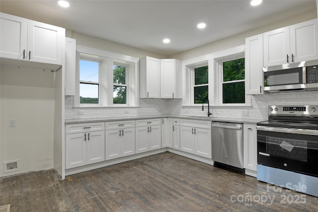 1783 Radio Station Rd, Newton, NC 28658 - kitchen with appliances with stainless steel finishes, a sink, backsplash, white cabinets, and recessed lighting
