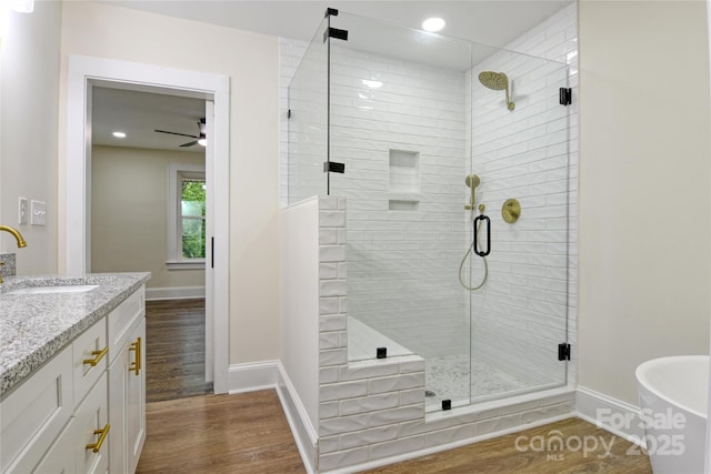 1783 Radio Station Rd, Newton, NC 28658 - bathroom featuring baseboards, wood finished floors, a shower stall, a soaking tub, and recessed lighting