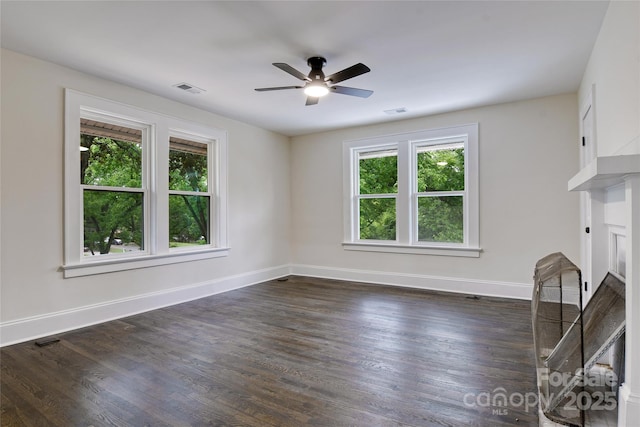 1783 Radio Station Rd, Newton, NC 28658 - unfurnished living room featuring plenty of natural light, a ceiling fan, dark wood finished floors, and baseboards