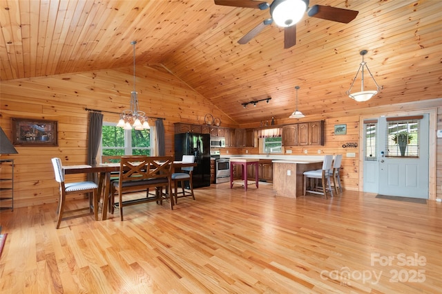 314 Prosperity Rdg, Waynesville, NC 28785 - dining area with wooden walls, wooden ceiling, a chandelier, light wood finished floors, and high vaulted ceiling