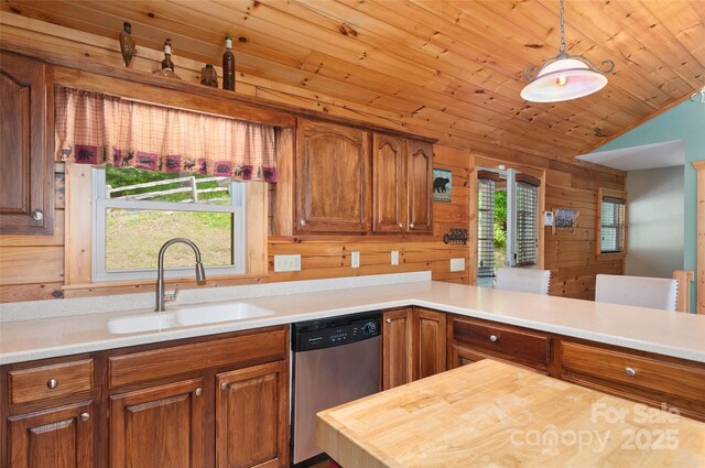314 Prosperity Rdg, Waynesville, NC 28785 - kitchen featuring stainless steel dishwasher, a sink, wood walls, brown cabinetry, and vaulted ceiling