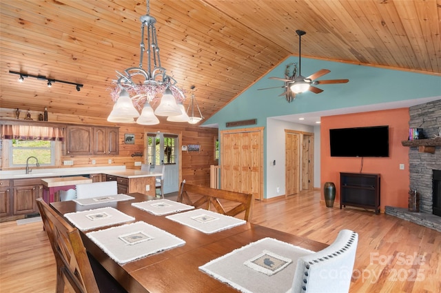 314 Prosperity Rdg, Waynesville, NC 28785 - dining room with light wood-type flooring, ceiling fan, high vaulted ceiling, wood ceiling, and a stone fireplace