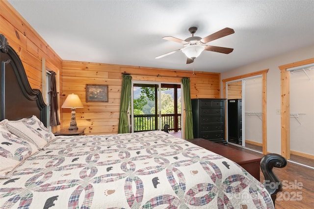 314 Prosperity Rdg, Waynesville, NC 28785 - bedroom with access to outside, wood finished floors, wood walls, multiple closets, and a ceiling fan