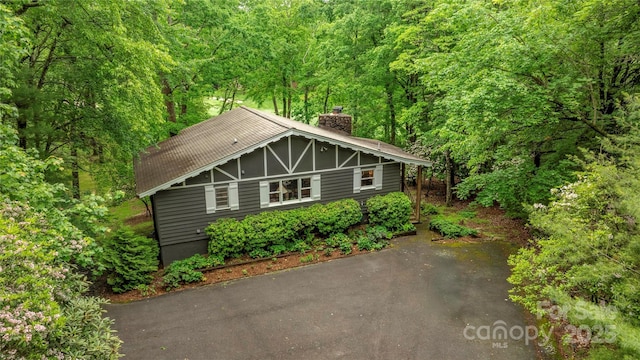 1207 Ridge Rd Unit 25, Glade Valley, NC 28627 - view of front facade with a chimney and a wooded view