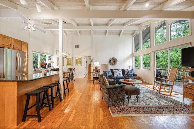 1207 Ridge Rd Unit 25, Glade Valley, NC 28627 - living room with high vaulted ceiling, ceiling fan, beamed ceiling, light wood finished floors, and baseboards