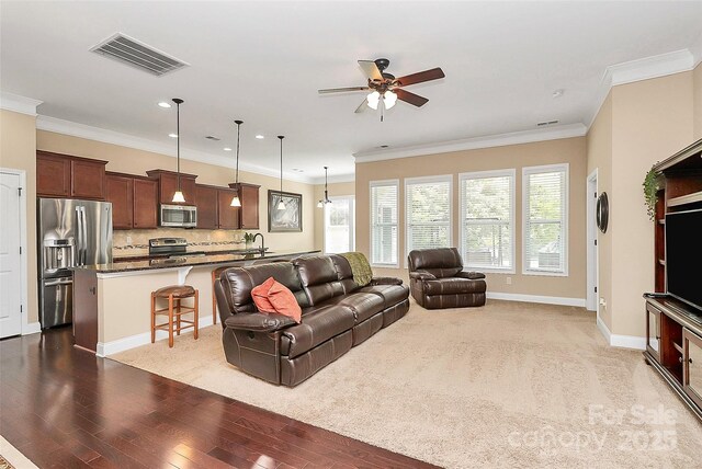 1397 Tupelo Rd, Clover, SC 29710 - living area featuring ceiling fan, wood finished floors, recessed lighting, crown molding, and baseboards