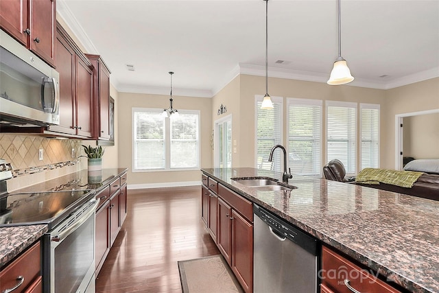 1397 Tupelo Rd, Clover, SC 29710 - kitchen featuring stainless steel appliances, a sink, backsplash, decorative light fixtures, and baseboards