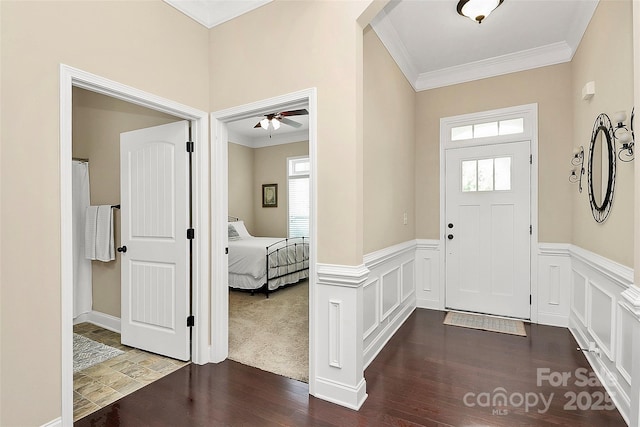 1397 Tupelo Rd, Clover, SC 29710 - entrance foyer with ornamental molding, dark wood-type flooring, wainscoting, and ceiling fan