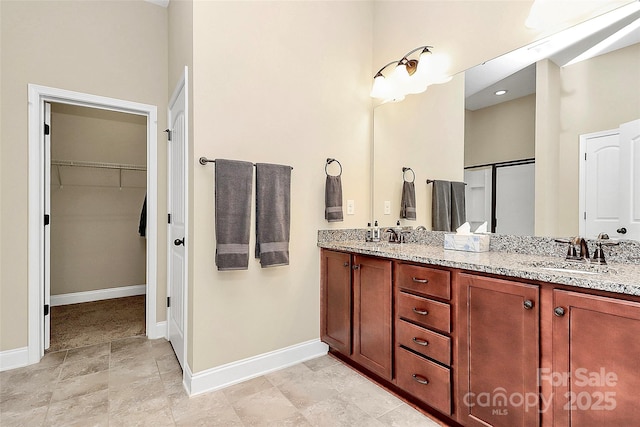1397 Tupelo Rd, Clover, SC 29710 - bathroom featuring baseboards, double vanity, and a spacious closet