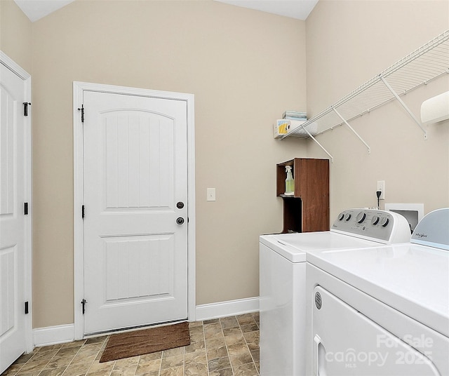 1397 Tupelo Rd, Clover, SC 29710 - washroom with washing machine and clothes dryer, baseboards, and stone finish floors