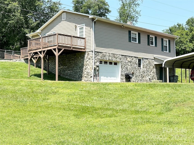 820 NE Seehorn St NE, Lenoir, NC 28645 - back of house featuring a yard, an attached garage, a wooden deck, and stone siding