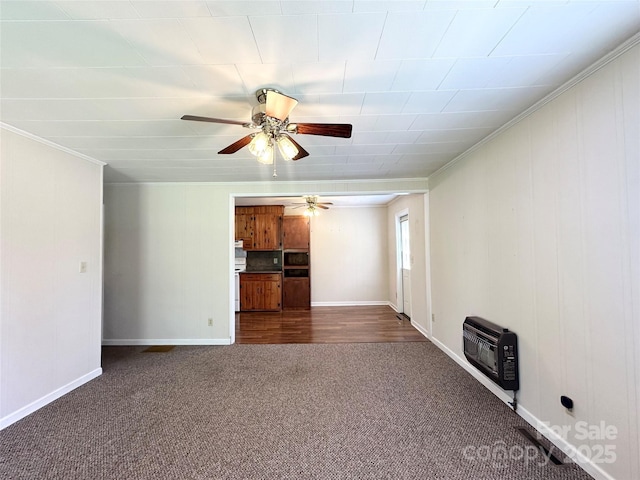 820 NE Seehorn St NE, Lenoir, NC 28645 - unfurnished living room featuring dark carpet, heating unit, ceiling fan, ornamental molding, and baseboards