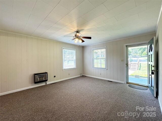 820 NE Seehorn St NE, Lenoir, NC 28645 - unfurnished living room with heating unit, crown molding, ceiling fan, carpet, and baseboards