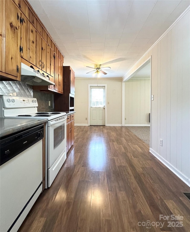 820 NE Seehorn St NE, Lenoir, NC 28645 - kitchen featuring white appliances, under cabinet range hood, brown cabinetry, dark wood-type flooring, and ceiling fan
