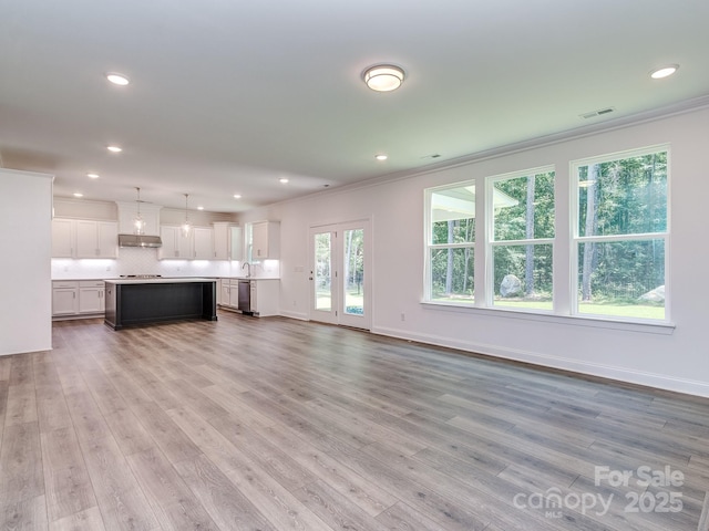 7108 Hambright Rd, Huntersville, NC 28078 - unfurnished living room with crown molding, light wood-type flooring, recessed lighting, and baseboards