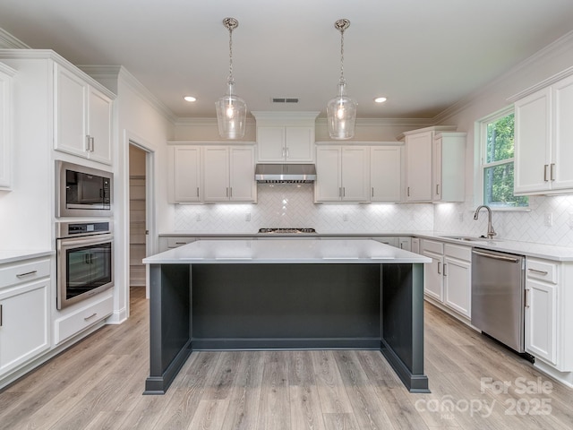 7108 Hambright Rd, Huntersville, NC 28078 - kitchen with appliances with stainless steel finishes, a sink, under cabinet range hood, white cabinetry, and backsplash