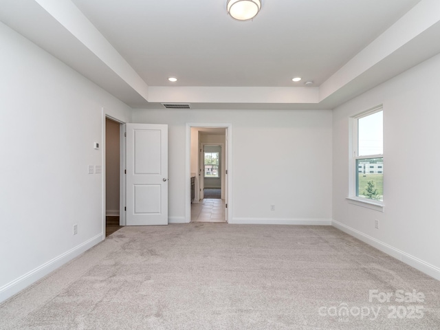 7108 Hambright Rd, Huntersville, NC 28078 - unfurnished bedroom featuring light colored carpet, multiple windows, baseboards, recessed lighting, and a raised ceiling