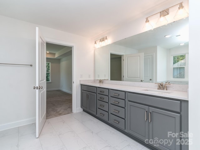7108 Hambright Rd, Huntersville, NC 28078 - bathroom with double vanity, marble look tile flooring, and baseboards