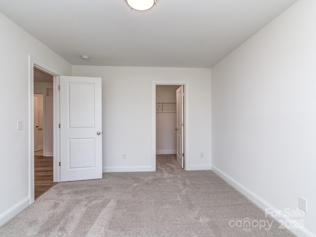 7108 Hambright Rd, Huntersville, NC 28078 - unfurnished bedroom with carpet floors, baseboards, a walk in closet, and a closet