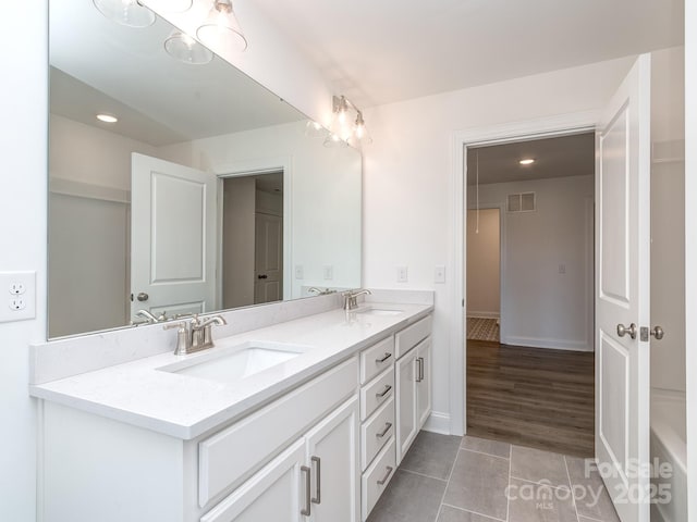 7108 Hambright Rd, Huntersville, NC 28078 - bathroom with double vanity, tile patterned flooring, baseboards, and recessed lighting