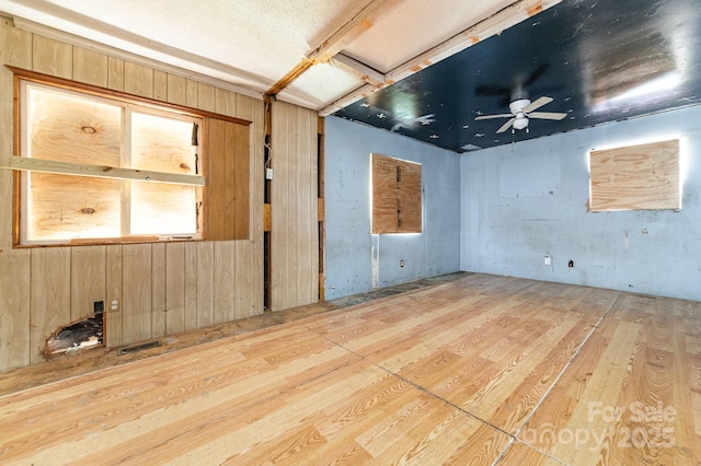 245 Walt Corriher Rd, China Grove, NC 28023 - unfurnished room with wood finished floors, ceiling fan, and wood walls