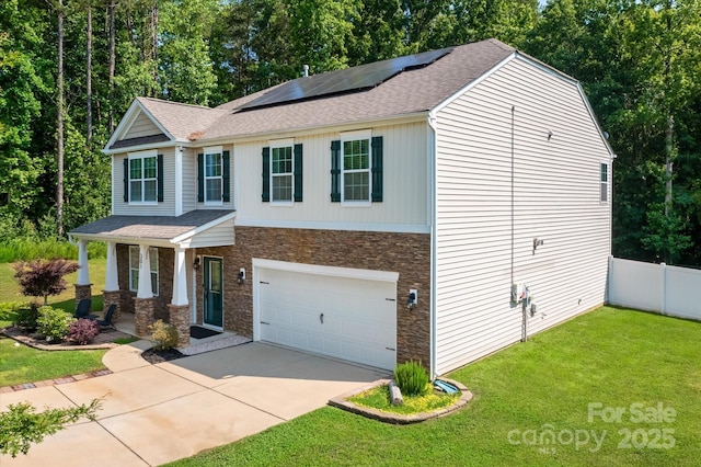 301 Wheat Field Dr, Mount Holly, NC 28120 - view of front of house with covered porch, stone siding, solar panels, a shingled roof, and driveway