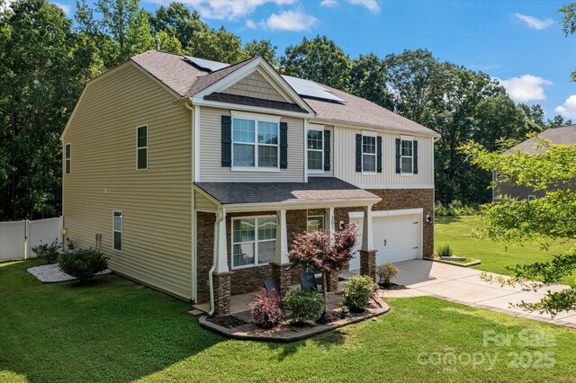 301 Wheat Field Dr, Mount Holly, NC 28120 - craftsman house with an attached garage, concrete driveway, stone siding, roof mounted solar panels, and roof with shingles