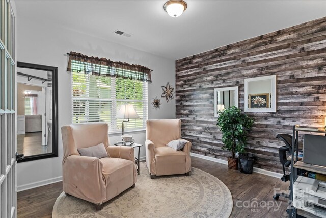 301 Wheat Field Dr, Mount Holly, NC 28120 - sitting room with wood walls, an accent wall, baseboards, and wood finished floors