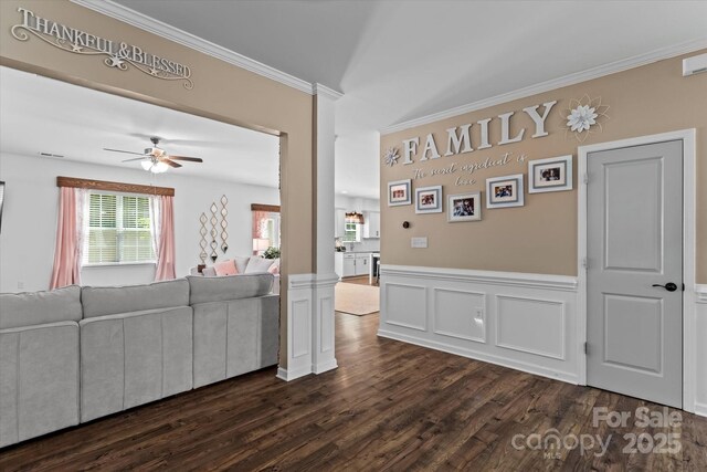 301 Wheat Field Dr, Mount Holly, NC 28120 - living area with ornamental molding, a ceiling fan, dark wood finished floors, and a wainscoted wall
