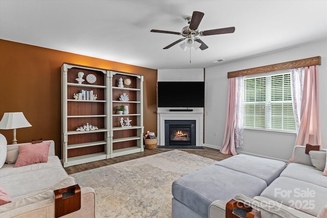 301 Wheat Field Dr, Mount Holly, NC 28120 - living area with ceiling fan, wood finished floors, a fireplace with flush hearth, and baseboards