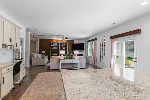 301 Wheat Field Dr, Mount Holly, NC 28120 - kitchen featuring a ceiling fan, light stone countertops, dark wood-style flooring, open floor plan, and white cabinets