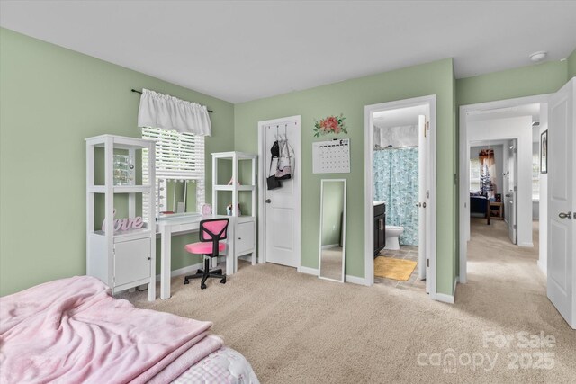 301 Wheat Field Dr, Mount Holly, NC 28120 - carpeted bedroom featuring baseboards and ensuite bath