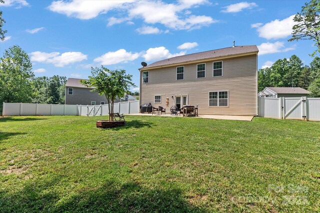 301 Wheat Field Dr, Mount Holly, NC 28120 - back of house featuring a gate and a patio