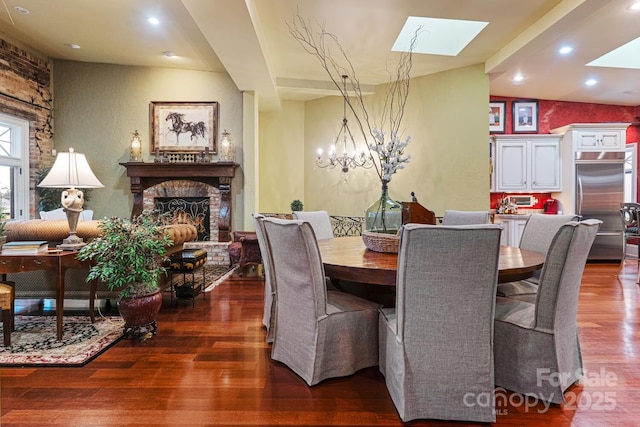 231 N Main St, Hendersonville, NC 28792 - dining room featuring a skylight, wood finished floors, a brick fireplace, recessed lighting, and a chandelier