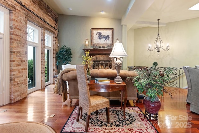 231 N Main St, Hendersonville, NC 28792 - sitting room with wood finished floors, a chandelier, and a fireplace