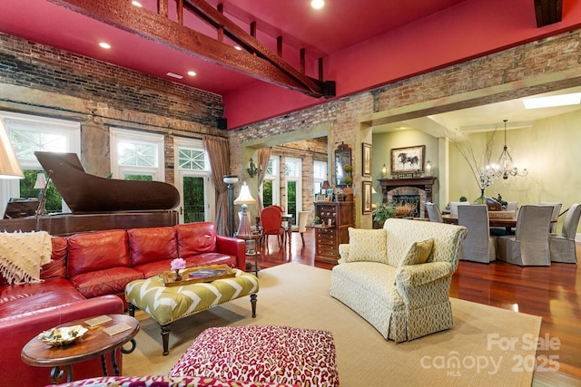 231 N Main St, Hendersonville, NC 28792 - living area with a fireplace, wood finished floors, a chandelier, recessed lighting, and a high ceiling