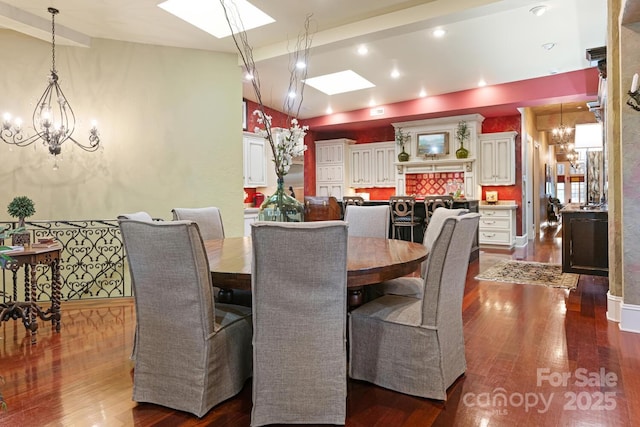 231 N Main St, Hendersonville, NC 28792 - dining area with a chandelier, a skylight, and dark wood-style flooring