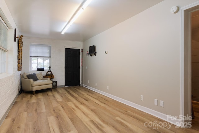 1028 Washburn Switch Rd, Shelby, NC 28150 - sitting room with light wood-style flooring, baseboards, and brick wall
