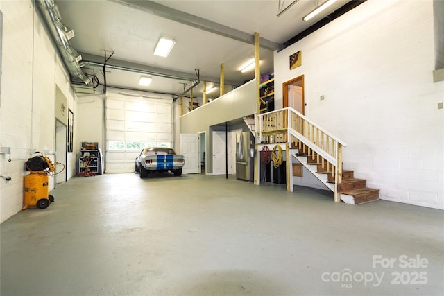 1028 Washburn Switch Rd, Shelby, NC 28150 - garage featuring concrete block wall and stainless steel refrigerator with ice dispenser