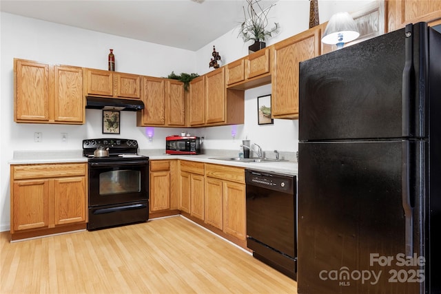 7138 Somerset Springs Dr, Charlotte, NC 28262 - kitchen featuring black appliances, under cabinet range hood, light wood-style flooring, and light countertops