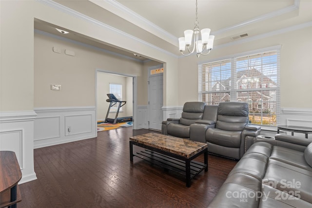 966 NW Parkland Pl, Concord, NC 28027 - living room with a chandelier, ornamental molding, a wainscoted wall, a decorative wall, and a tray ceiling
