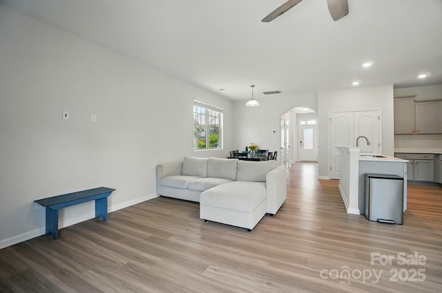 5334 Orchid Bloom Dr, Fort Mill, SC 29707 - living room featuring arched walkways, light wood finished floors, a ceiling fan, recessed lighting, and baseboards