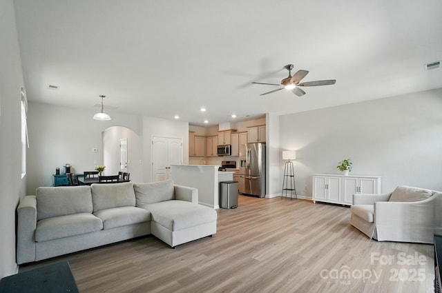 5334 Orchid Bloom Dr, Fort Mill, SC 29707 - living room featuring arched walkways, ceiling fan, light wood-type flooring, recessed lighting, and baseboards