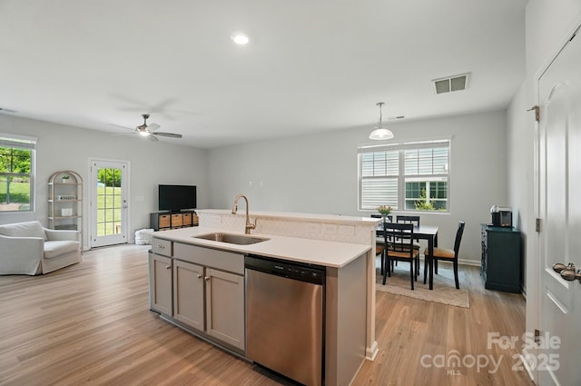 5334 Orchid Bloom Dr, Fort Mill, SC 29707 - kitchen with stainless steel dishwasher, a sink, open floor plan, light wood-style floors, and recessed lighting