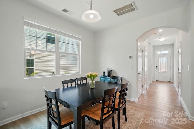 5334 Orchid Bloom Dr, Fort Mill, SC 29707 - dining room featuring arched walkways, light wood finished floors, and baseboards