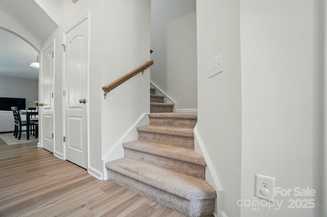 5334 Orchid Bloom Dr, Fort Mill, SC 29707 - stairs featuring wood finished floors, arched walkways, and baseboards