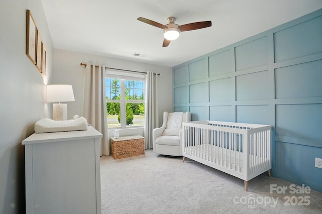 5334 Orchid Bloom Dr, Fort Mill, SC 29707 - bedroom featuring light colored carpet, a nursery area, a decorative wall, and ceiling fan